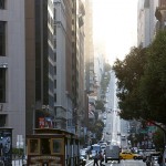 Sunlight filters through California Street while riding Cable Car