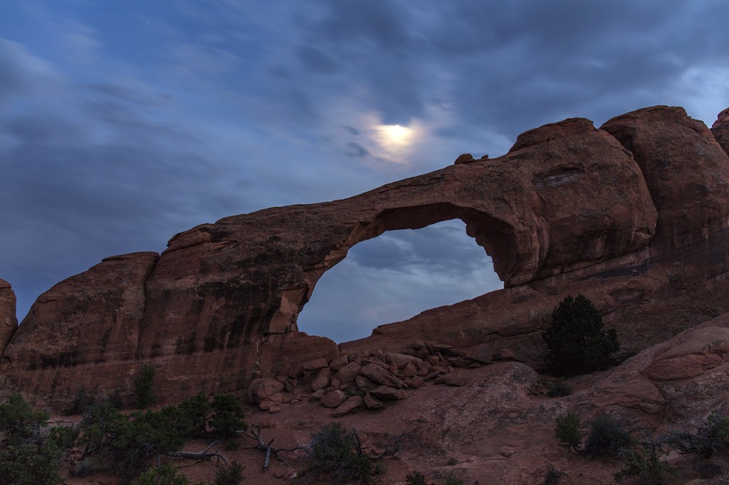 Skyline Arch with moon shining through the clouds, Arches National Park, Utah, USA
