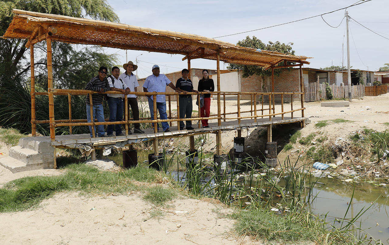 Bridge building across sewage drains, Polvorines, Piura, Peru