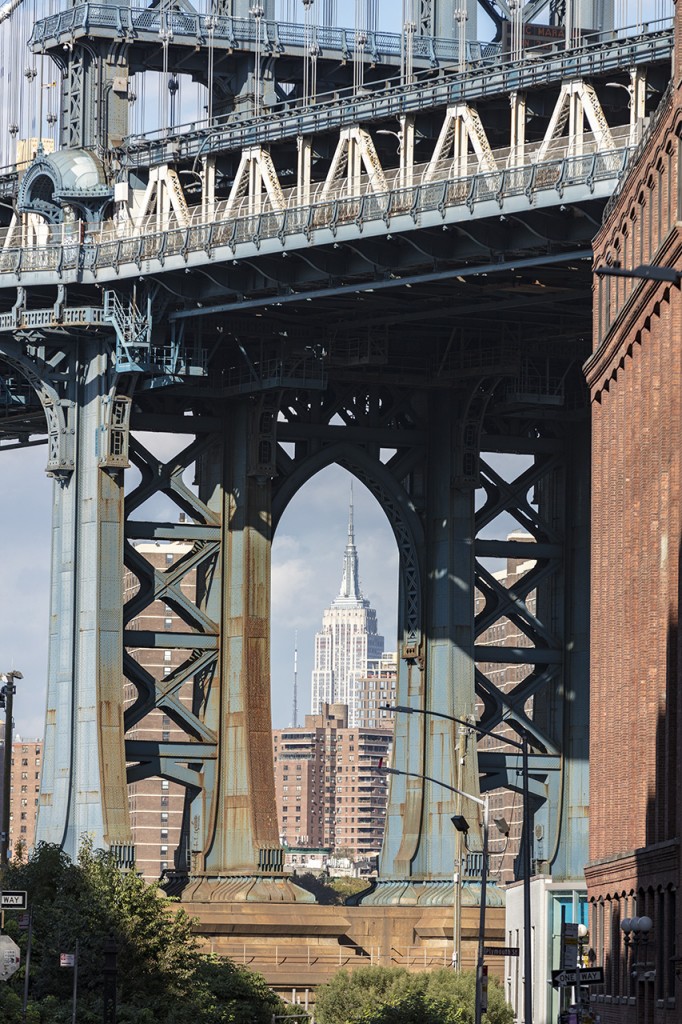 Empire State Building through Brooklyn Bridge, New York, USA