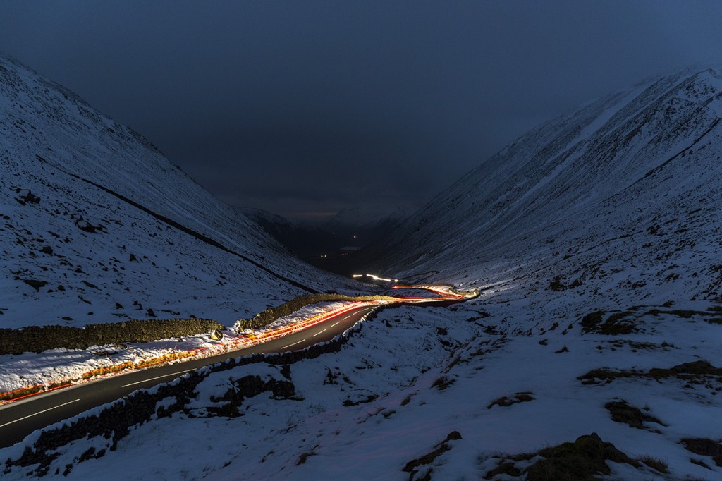 Kirkstone Pass illuminated by headlights of passing car, Lake District, United Kingdom